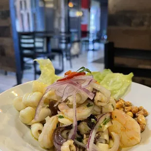 a plate of pasta with shrimp and vegetables
