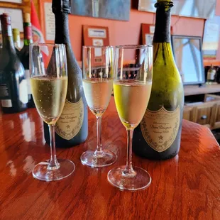 three glasses of wine and two bottles of wine