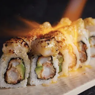 a piece of sushi on a cutting board