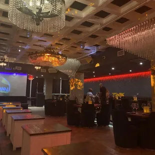 a view of a dining room with chandeliers