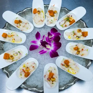 a platter of appetizers with a purple flower