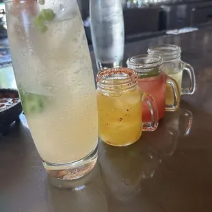 Spicy Mezcal Paloma and a Mini Margarita Flight (L to R) Mango Tajin, Watermelon Basil, and Pineapple Jalapeño.