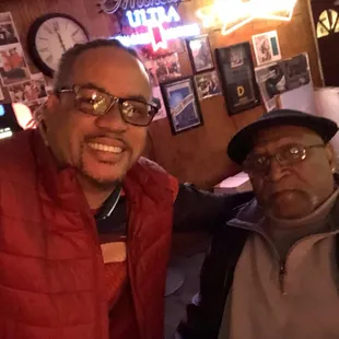 two men taking a selfie in a bar