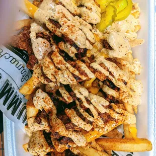Loaded Nashville Fries Fries topped with Crispy Hot Chicken, Nashville Sauce, Seasoning and Pickle.