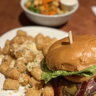a burger with bacon and lettuce