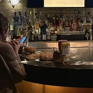 a woman sitting at a bar