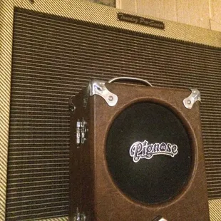 a brown amp and a brick wall
