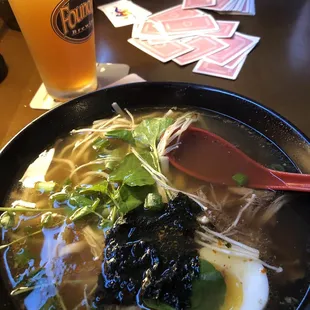 a bowl of soup and a glass of beer