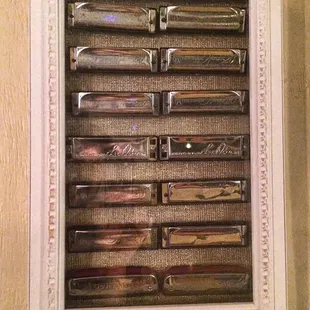 a collection of knives in a white frame