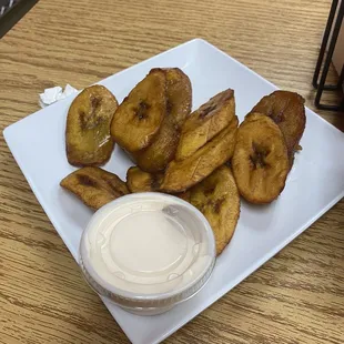 a plate of fried bananas and dip