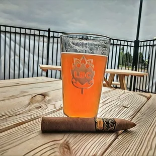 a cigar and a glass of beer