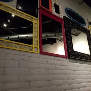 a row of mirrors on a wall