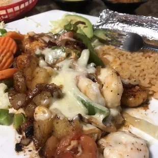Shrimp ranchero with vegetables and rice and sliced avocado