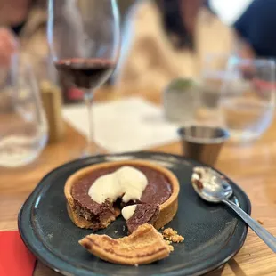 a chocolate tart with a bite taken out of it
