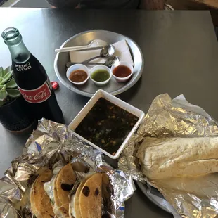 Salsas, Birria queso tacos, and al pastor burrito IG @denjeneats