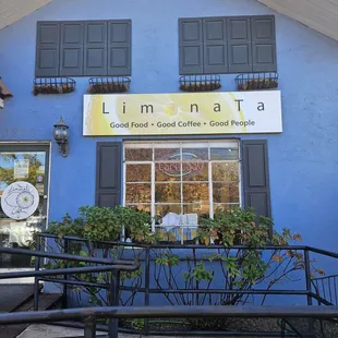 a blue building with black shutters