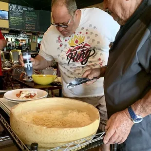 a man and a woman preparing a cake