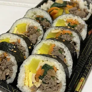 a plate of sushi rolls