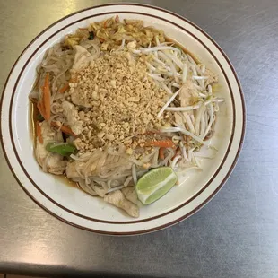 a plate of noodles with meat and vegetables