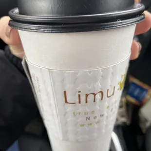 a hand holding a cup of coffee