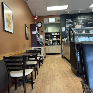 Tables next to barista area and leading to bathroom.