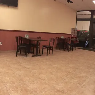 the inside of a restaurant with tables and chairs
