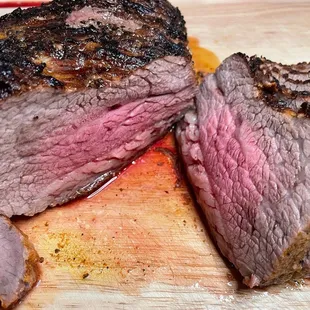a sliced steak on a cutting board