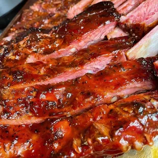 a close up of ribs on a cutting board