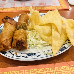 a plate of spring rolls and chips