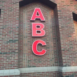 a brick building with a large abc sign
