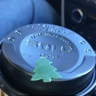 a coffee cup with a christmas tree on it