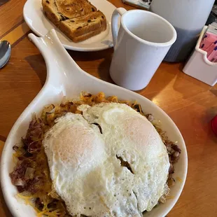Irish Skillet with two eggs, corned beef hash, onions, peppers and cheese on a bed of hash browns.