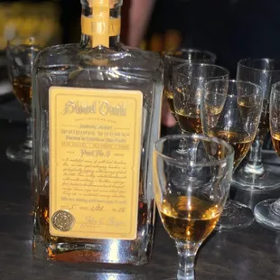 a bottle of whiskey and glasses