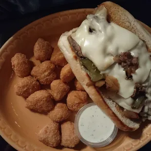 a cheeseburger and tater tots on a plate