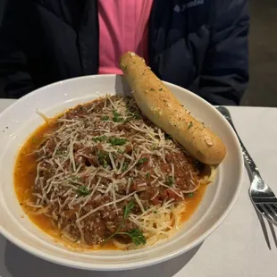 a bowl of spaghetti and bread