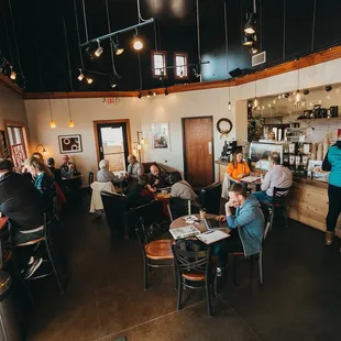 people sitting at tables in a restaurant