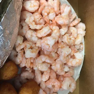 a plate of shrimp and tater tots