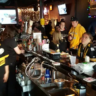 a crowd of people at a bar