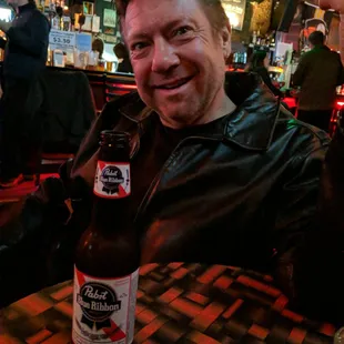 a man holding a beer