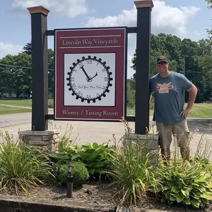 a man standing in front of a sign