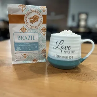 a cup of coffee next to a bag of coffee