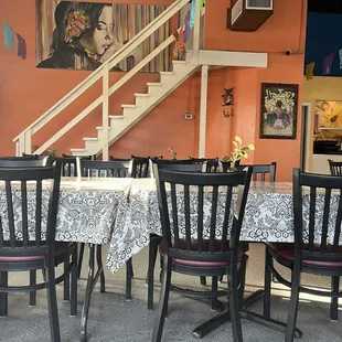 a dining area with tables and chairs