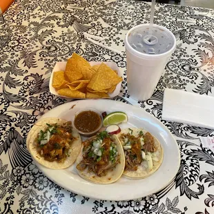 Three tacos, chips, and a drink about $10.