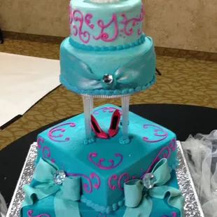 a three tiered cake with a bride and groom on top