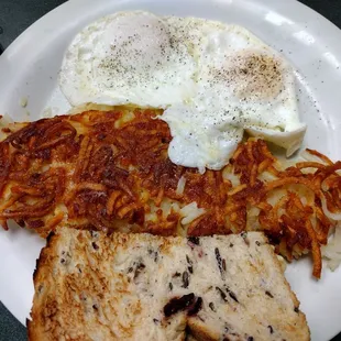 Two eggs, hash browns and cranberry wild rice bread.