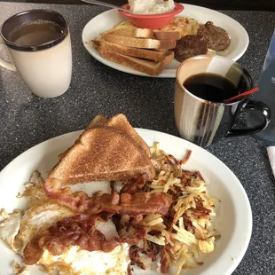 Western omelette with sausage, patties, and grits. Two eggs over easy with hashbrowns and bacon.