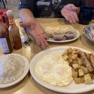 Eggs and sausage links with biscuits and gravy