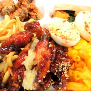 Box from the Buffet: chicken livers, deviled eggs, sesame chicken wings, lo mein, orange chicken, kim chi, spinach