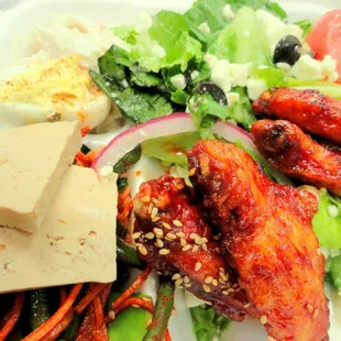 Box from the buffet:  marinated tofu, cold green beans, kim chee, cold spinach, sesame chicken wings, Greek salad, deviled egg