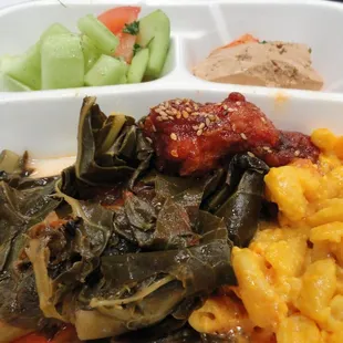 Box from the buffet:  collards, mac 'n' cheese, cucumber and tomato salad, marinated tofu, kim chee, sesame chicken wing